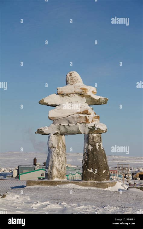 Inuksuk or Inukshuk landmark covered in snow found on a hill in the ...