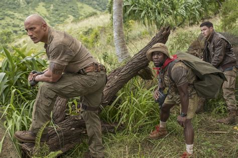 Dwayne Johnson smolders as a video game action hero in “Jumanji”