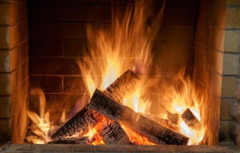 Premium Photo | Fire in the fireplace of a country house cold winter ...