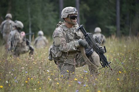 HD wallpaper: four soldiers holding assault rifles with scopes near gray helicopter | Wallpaper ...