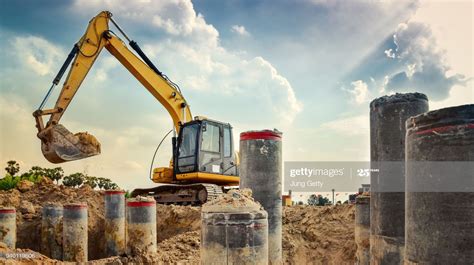 Foto de stock : excavator blue sky heavy machine construction site soil excavate for foundation ...