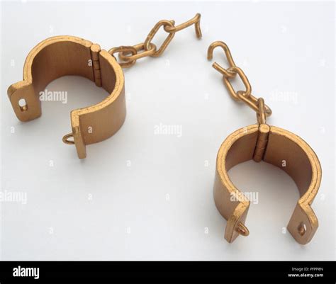 Pair of golden handcuffs with broken chains, close-up Stock Photo - Alamy