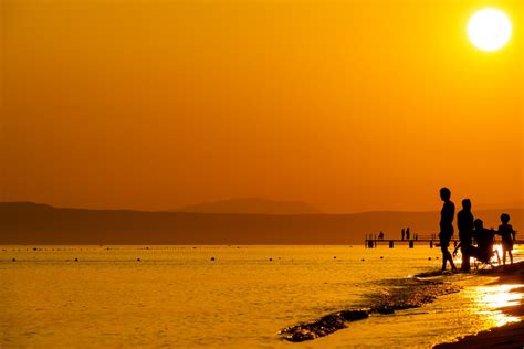 People on the Beach During Sunset · Free Stock Photo