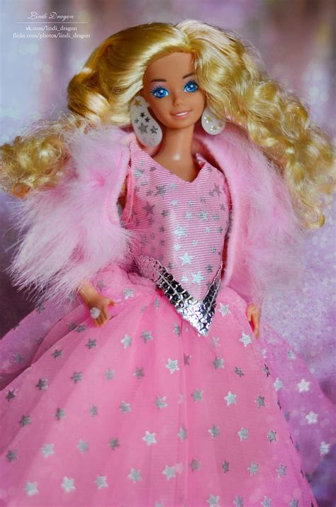 a barbie doll with blonde hair and blue eyes wearing a pink dress in ...