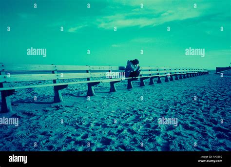 Woman Sitting on Bench Looking Sad Stock Photo - Alamy