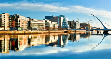 Modern buildings and offices on Liffey river in Dublin on a bright sunny day | Ireland Vacations ...