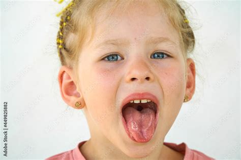 Cheerful child. Girl laughs close-up of the face on a white background ...