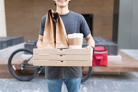 Young Delivery Man with Food Parcel Stock Image - Image of midsection ...