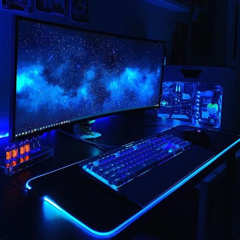 a desk with a keyboard, mouse and monitor lit up