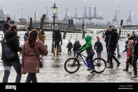 Hamburg, Germany. 30th Jan, 2022. Onlookers watch the flooding caused ...