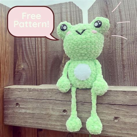 Green frog crochet pattern, bulging eyes, white belly.