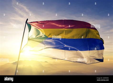 Druze flag waving on the top sunrise mist fog Stock Photo - Alamy