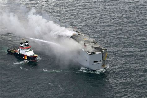 Burning cargo ship off Dutch coast will be towed to a new location after flames and smoke subsided