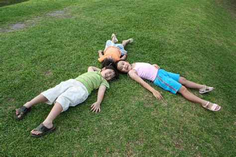 Kids lying on the grass stock image. Image of life, lawn - 5622901