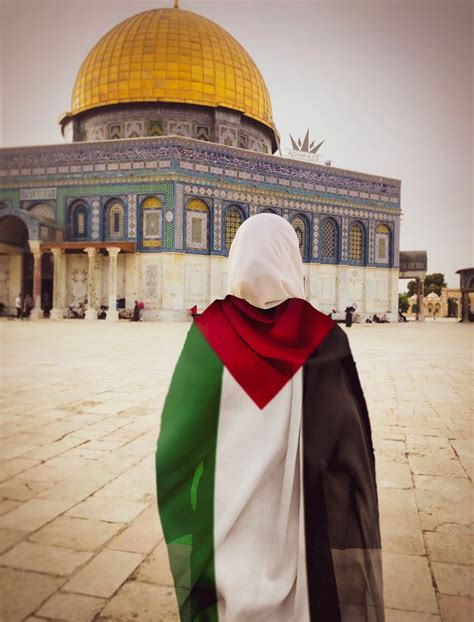 a person wearing a flag in front of a building