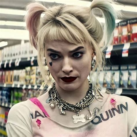 a woman with pigtails and piercings on her head standing in a store aisle