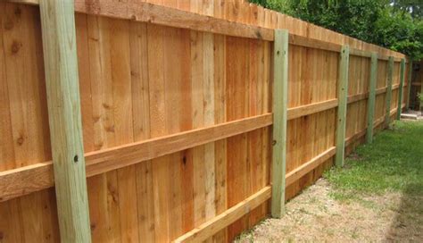 a wooden fence is shown in the grass