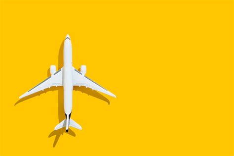 Premium Photo | Airplane on a yellow background travel and flights