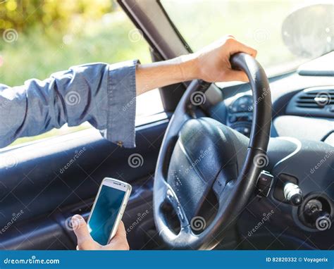 Man Using His Phone while Driving Car. Stock Photo - Image of ...