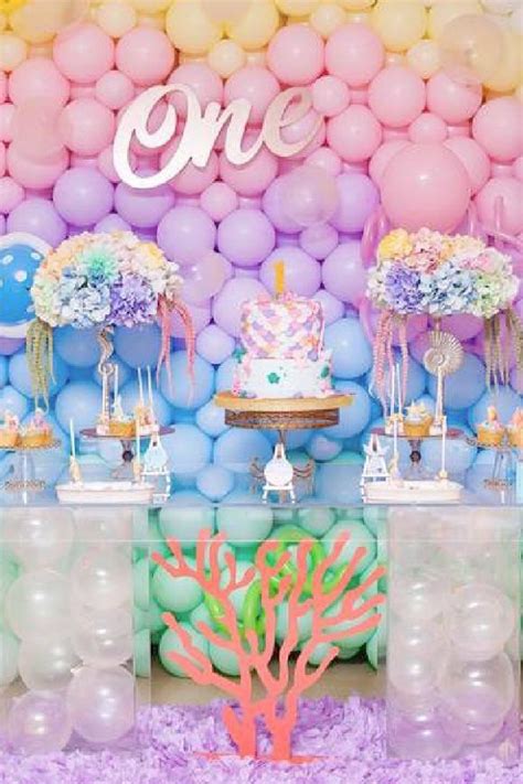 a birthday party with balloons, cake and decorations