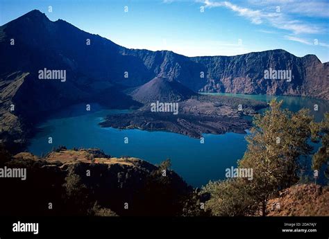 Mount Rinjani (or Gunung Rinjani) landscape at crater rim overlooking into crater lake and its ...