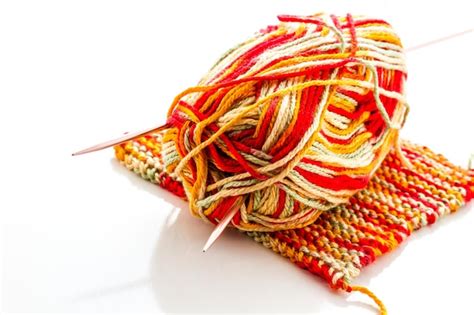 Premium Photo | Knitting with multi colored yarn with orange, red, and ...