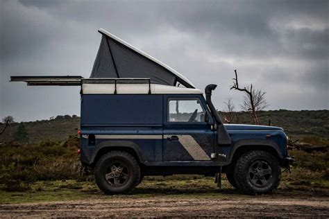 This Land Rover Defender camper’s pop-up roof unveils a lavish wooden cabin - Yanko Design