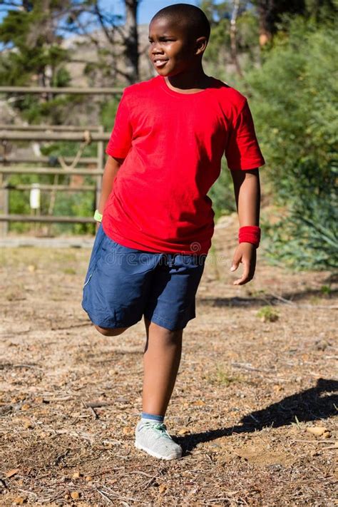 Boy Performing Stretching Exercise during Obstacle Course Training ...