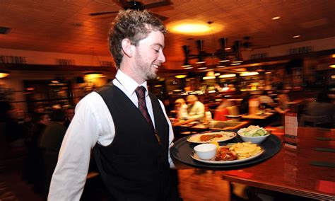 A waiter rushes with a tray of food in a busy restaurant Bradford West Yorkshire. | Spring ...