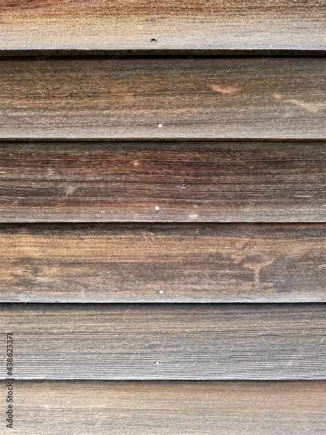 Old cedar clapboard siding worn by the elements. Stock Photo | Adobe Stock