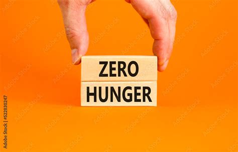 Zero hunger symbol. Concept words Zero hunger on wooden blocks on a beautiful orange table ...