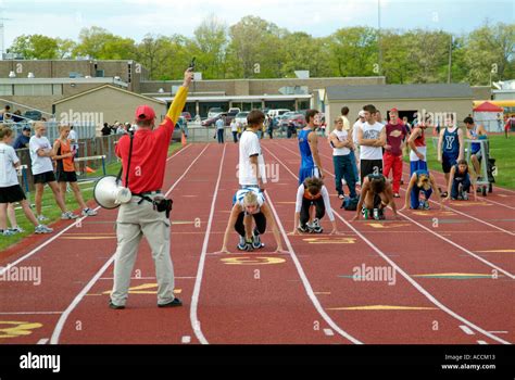 High School Track and Field Events starter fires gun to start a race Stock Photo: 4281362 - Alamy