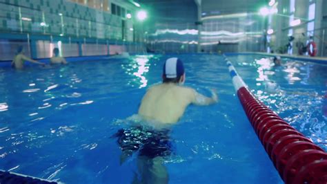 Swimming pool and swimmer during training. Training of athletes in pool ...