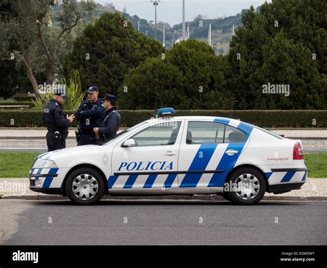 Three portuguese police officers next to a police car in Lisbon, Portugal Stock Photo - Alamy