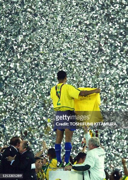 TOPSHOT - Brazil's defender and team captain Cafu holds a Brazilian ...