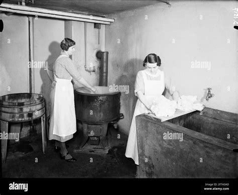 Washing stew 120 liters. In laundry room with 2 ladies Stock Photo - Alamy