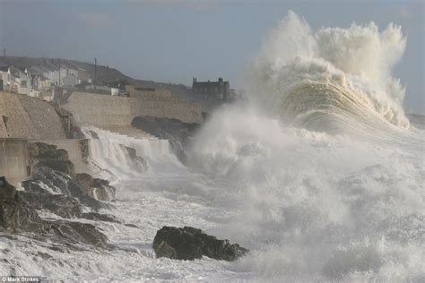 Biggest storm of the year sweeps Britain off its feet with flooding, gales and lightning strikes ...