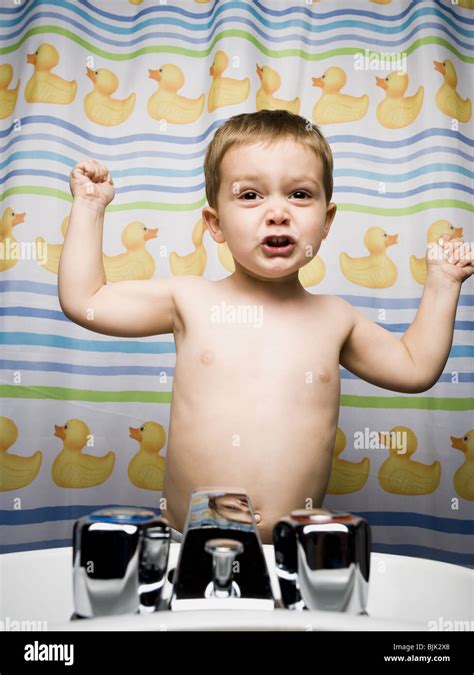 Boy flexing muscles in bathroom Stock Photo - Alamy