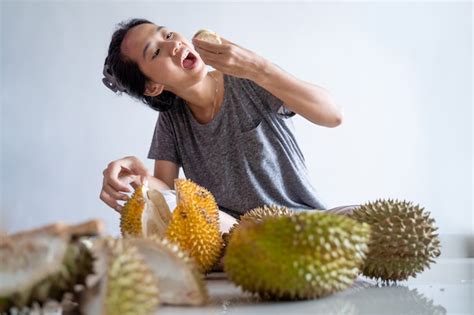 Premium Photo | Woman enjoy eating durian fruit