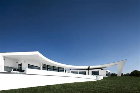 Arc House with Luxury Interiors and Edgy Curved Roof