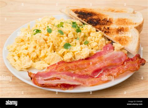 Scrambled eggs with streaky bacon breakfast with slices of toast ...