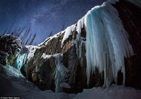 Photographer braves -30C temperatures to capture ice climbers scaling frozen waterfalls at night ...