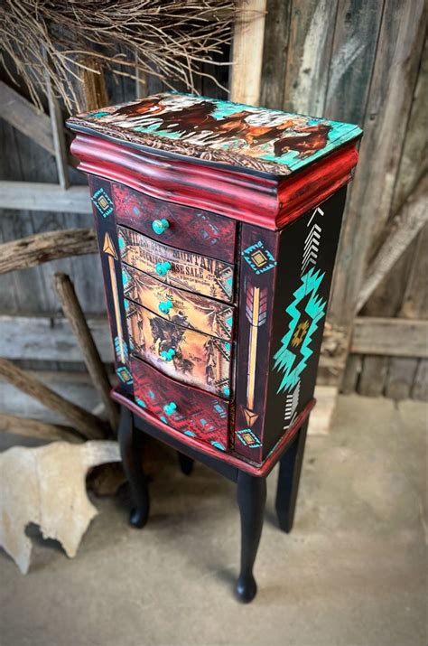 a colorful painted cabinet sitting on top of a wooden floor next to a ...