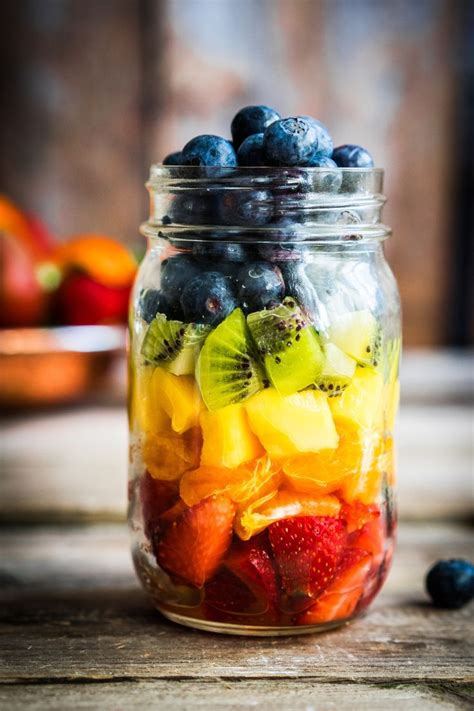 Colourful fruit salad on a jar with strawberry, orange, pineapple, kiwi and blueberry. Great ...