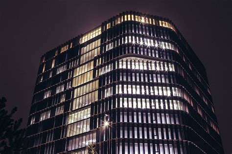 Royalty-Free photo: Office building at night with lights on | PickPik