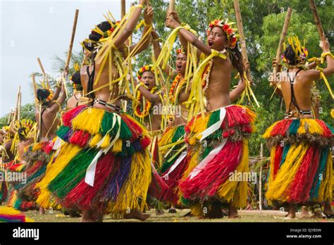 Yapese girls in traditional clothing dancing with bamboo pole at Yap Day Festival, Yap Island ...