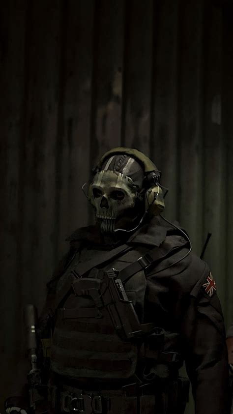 a man wearing a helmet and uniform with a skull on it's face, standing ...