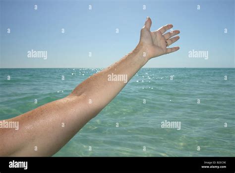 an arm reaching out over the water Stock Photo - Alamy