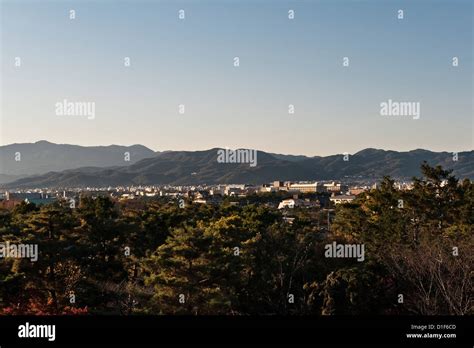 A view of the city of Kyoto, Honshu, Japan, surrounded by mountains ...