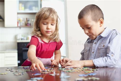 Children, playing puzzles stock photo. Image of concentration - 18717628